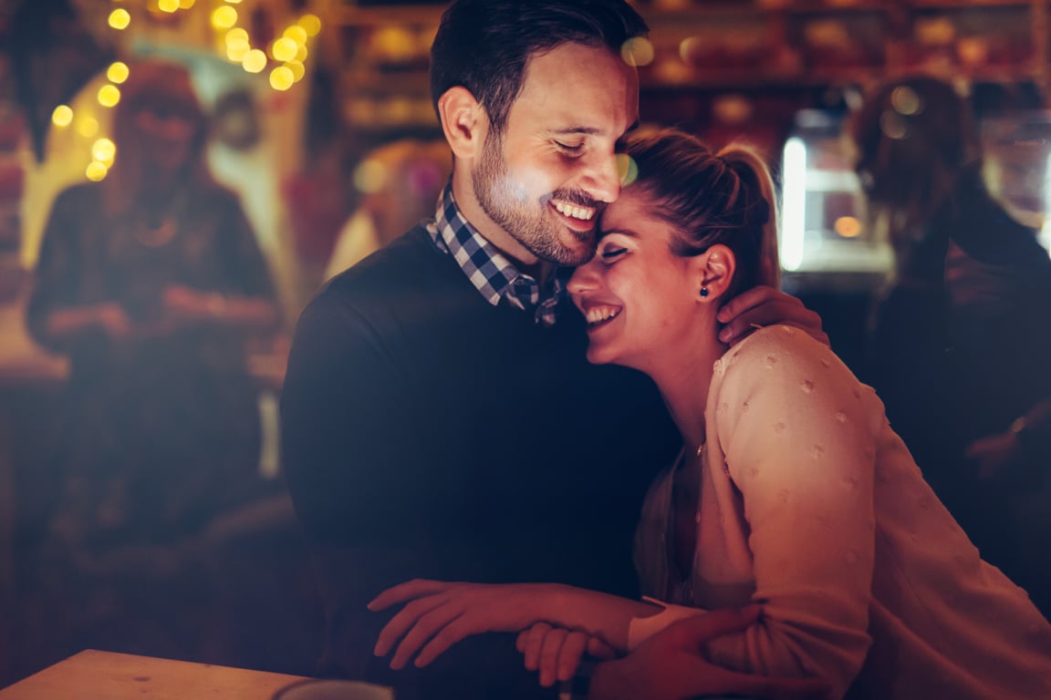 Romantic couple dating in pub at night