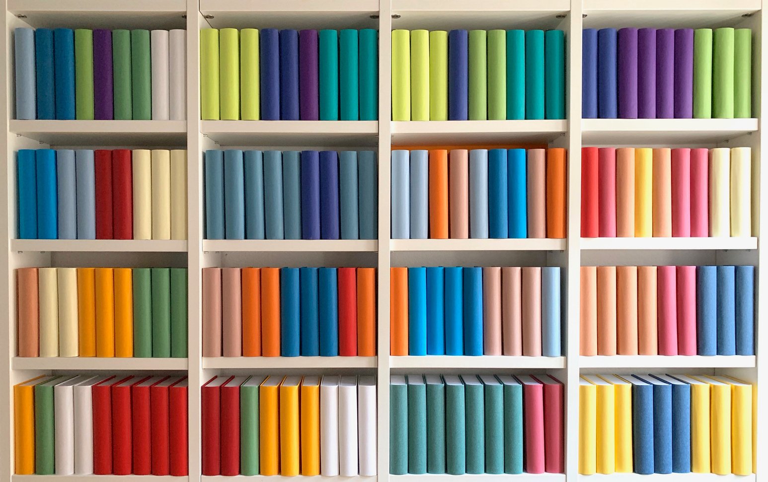 Colorful generic books in white book shelves